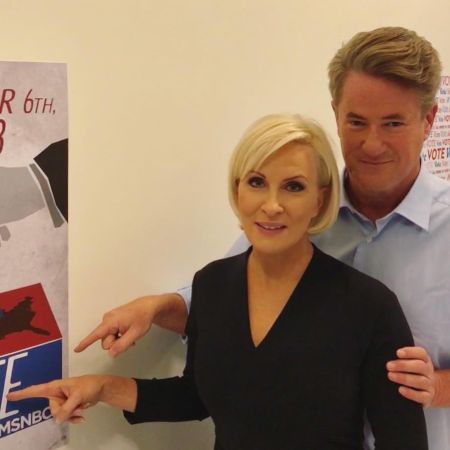 Joe and Mika pointing at the poster
